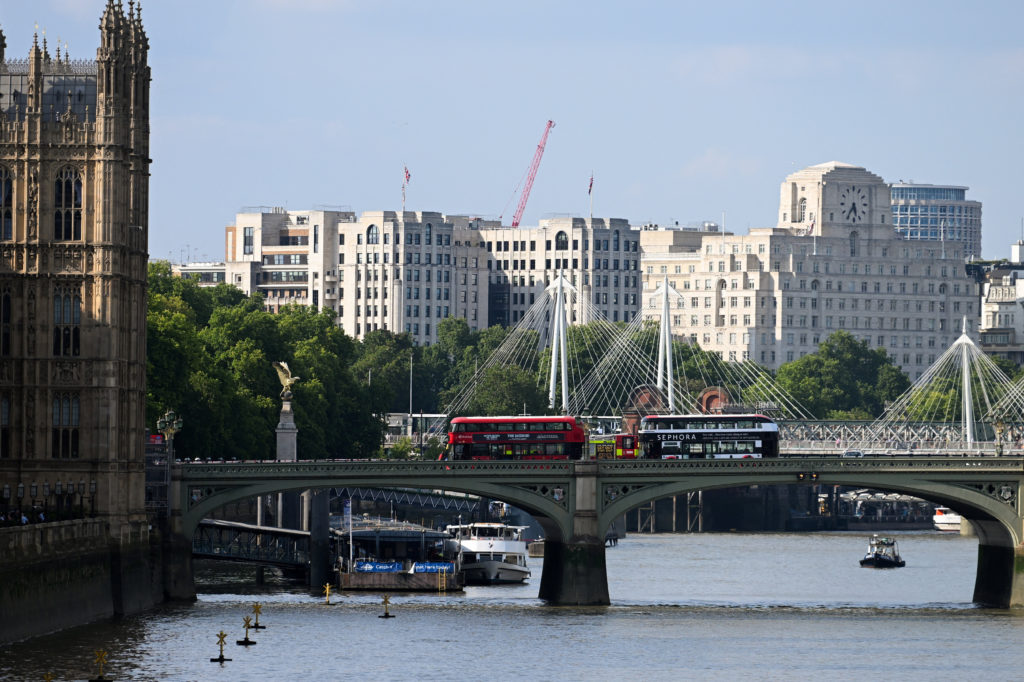 Police boat collides with Westminster Bridge in London, officers enter River Thames